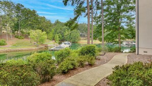 A lakeside view with boats docked, surrounded by dense trees and a clear sky. - Lake Keowee Resort Condo w/ Fantastic View (Salem)