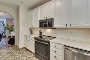 A kitchen with white cabinets, a microwave, an oven, and a dishwasher. - Lake Keowee Resort Condo w/ Fantastic View (Salem)