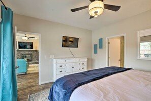 A bedroom with a bed, a ceiling fan, a dresser, and a television. - Lake Keowee Condo With Fantasitic View and Resort (Salem)
