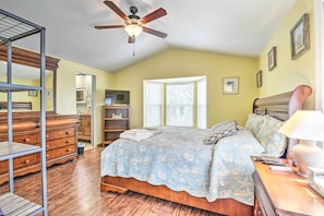 A bedroom with a bed, wooden dresser, and a ceiling fan. - Surfside Beach Home w/ Resort Perks: Walk to Beach (Murrells Inlet)