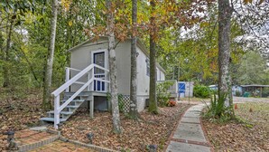 A small, single-story building with a white staircase leading to a door. - 'the Driftwood Cottage' w/ Patio & Free Wifi! (Quincy)