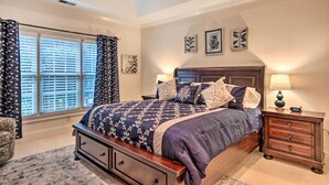 A bedroom with a bed, nightstands, a ceiling fan, and a window with blinds. - Upscale Home w/ Poker Room < 1 Mi to Golf! (Aiken)
