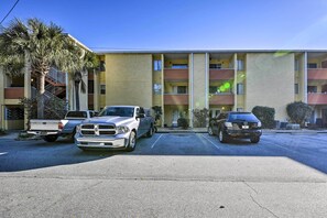 A multi-story building with a parking lot.