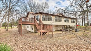 A two-story house with a deck and a covered porch. - 40-acre Poplar Bluff Nature Lovers Paradise! (Poplar Bluff)