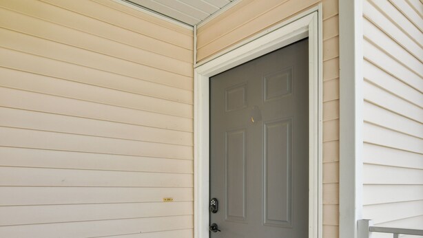 A closed gray door with a white frame, set in a beige siding exterior. - Branson Condo w/ Pool: 2 Mi to Table Rock Lake (Branson)