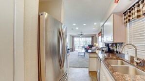 A modern kitchen with stainless steel appliances, granite countertops, and a central island. - Branson Condo w/ Balcony, Near Silver Dollar City! (Branson)