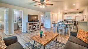 A spacious living room with a wooden coffee table, gray sofas, and a ceiling fan. - Branson Condo ~ 6 Mi to Silver Dollar City! (Branson)