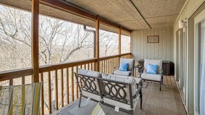 A covered porch with wooden railings, a sofa set, and a small table. - Family-friendly Condo: 1 Mi to Silver Dollar City! (Branson West)