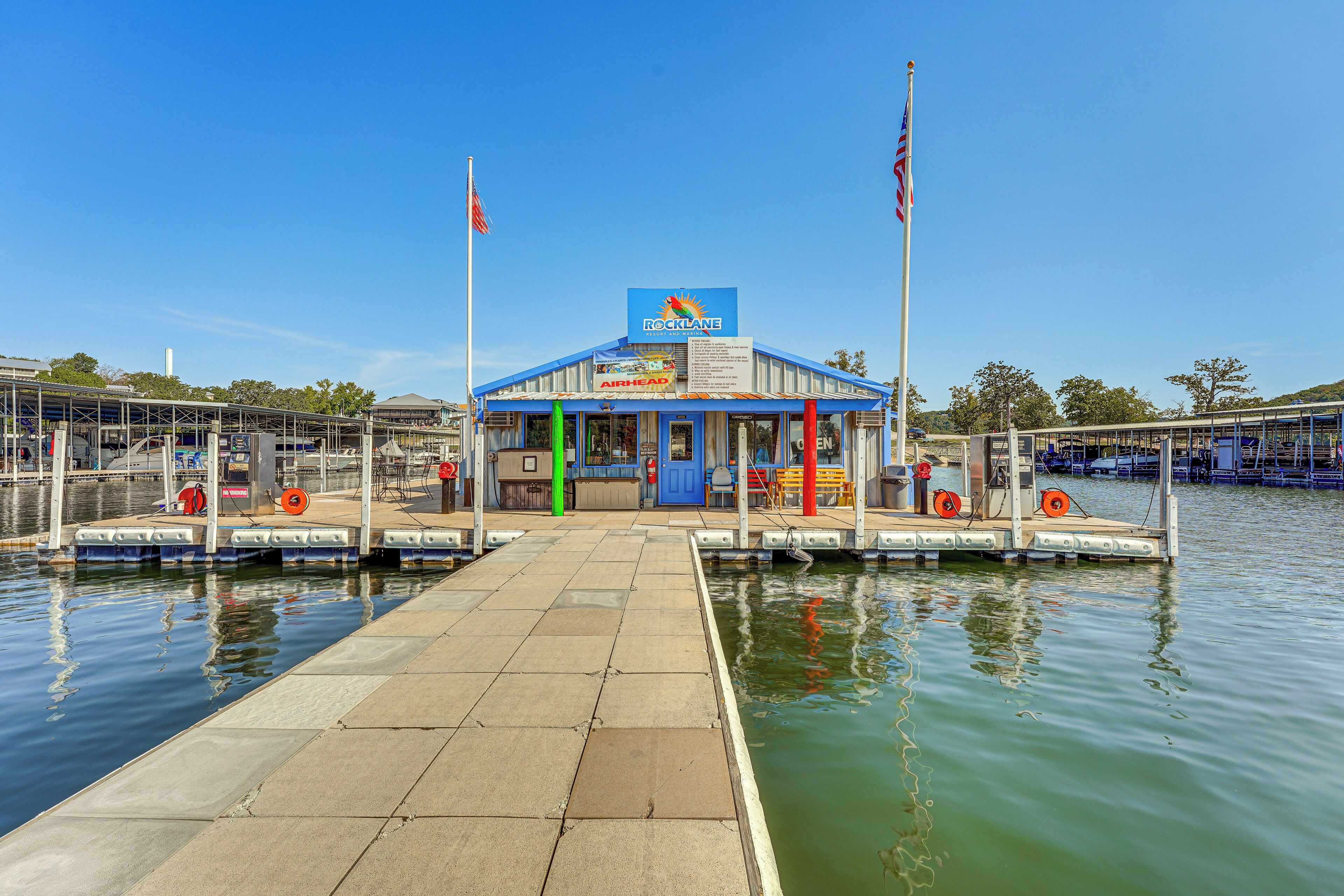 A docked boat with a blue and white building labeled "Rocklane" and "Airhead" in the background.