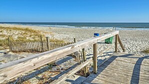 A wooden boardwalk leading to a sandy beach with a clear blue sky. - 1 Block to Beach! Breezy Myrtle Beach Getaway (Myrtle Beach)