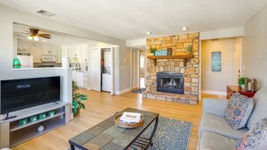 A spacious living room with a fireplace, a television, and a sofa.