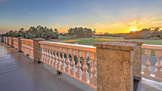 A balcony with a view of a golf course at sunset. - 10 Mi to Beach: Legends Resort Condo on Ninth Hole (Myrtle Beach)