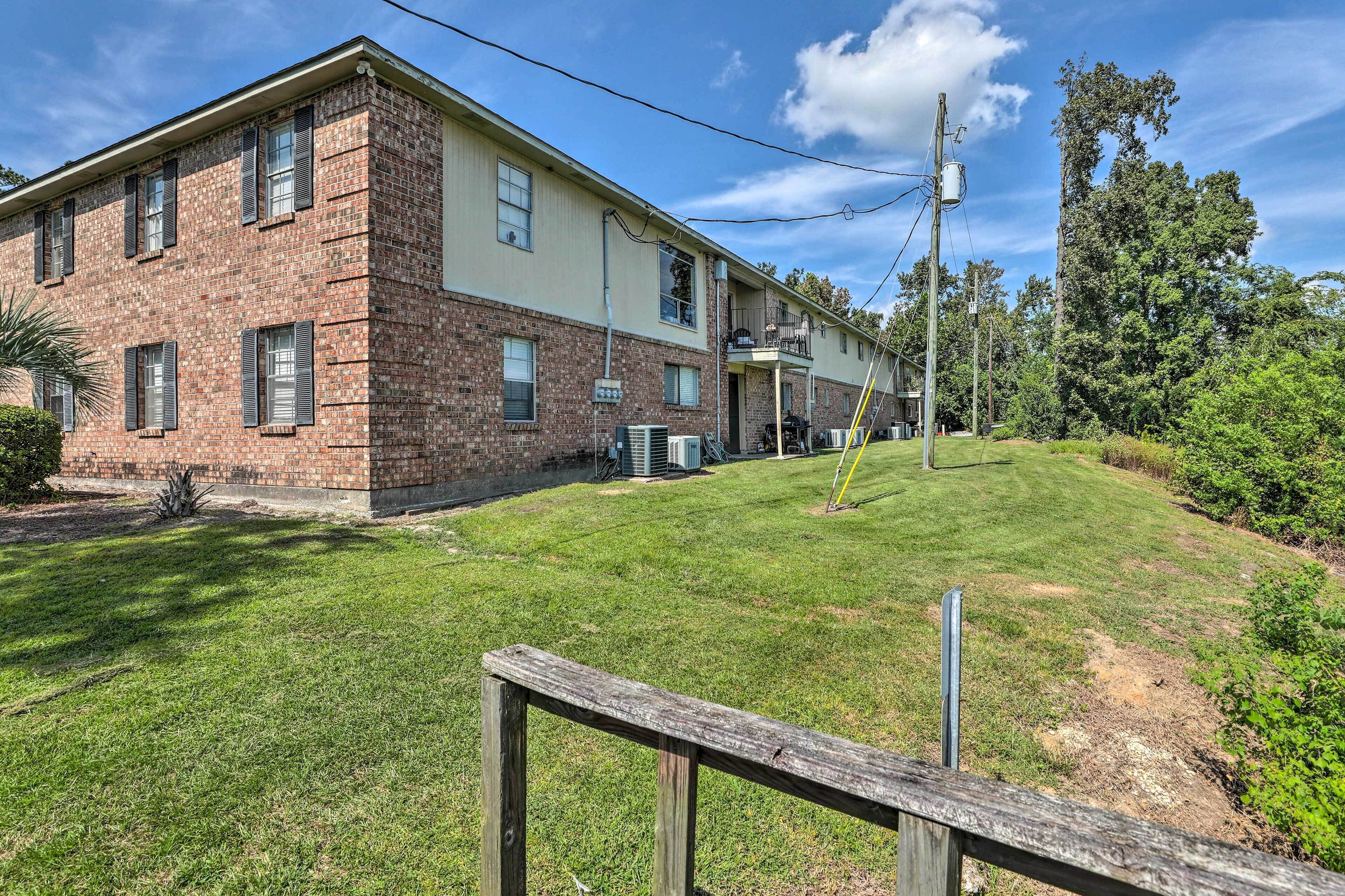 A two-story brick building with a flat roof and a small front porch.