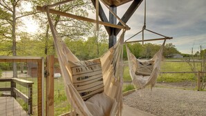 Two hammocks with pillows labeled "BENEFIT LIFE" hanging from a wooden structure. - Waterfront Home Near Mark Twain National Forest (Poplar Bluff)