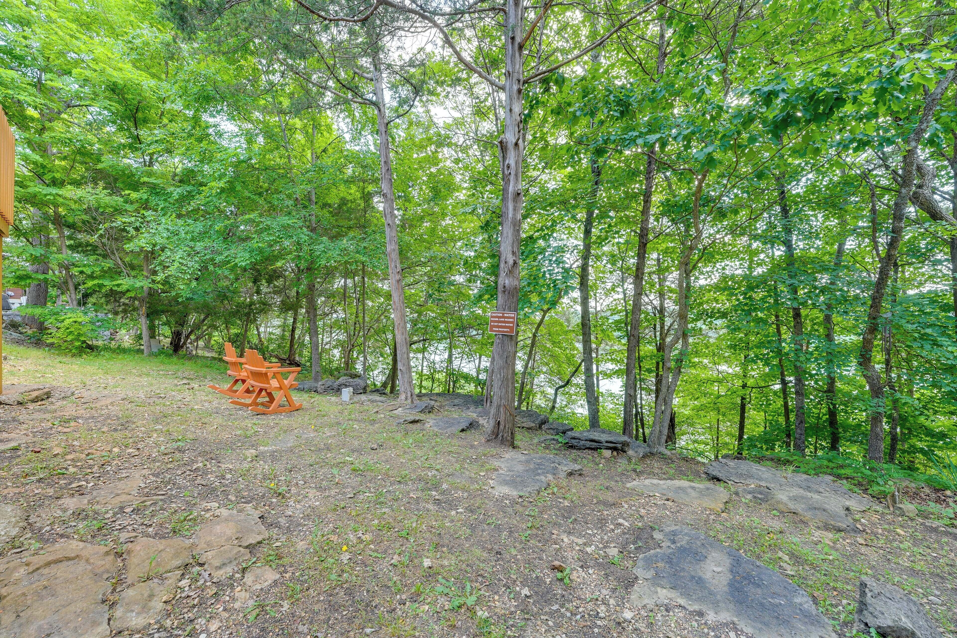 A forested area with a picnic table and a sign on a tree.