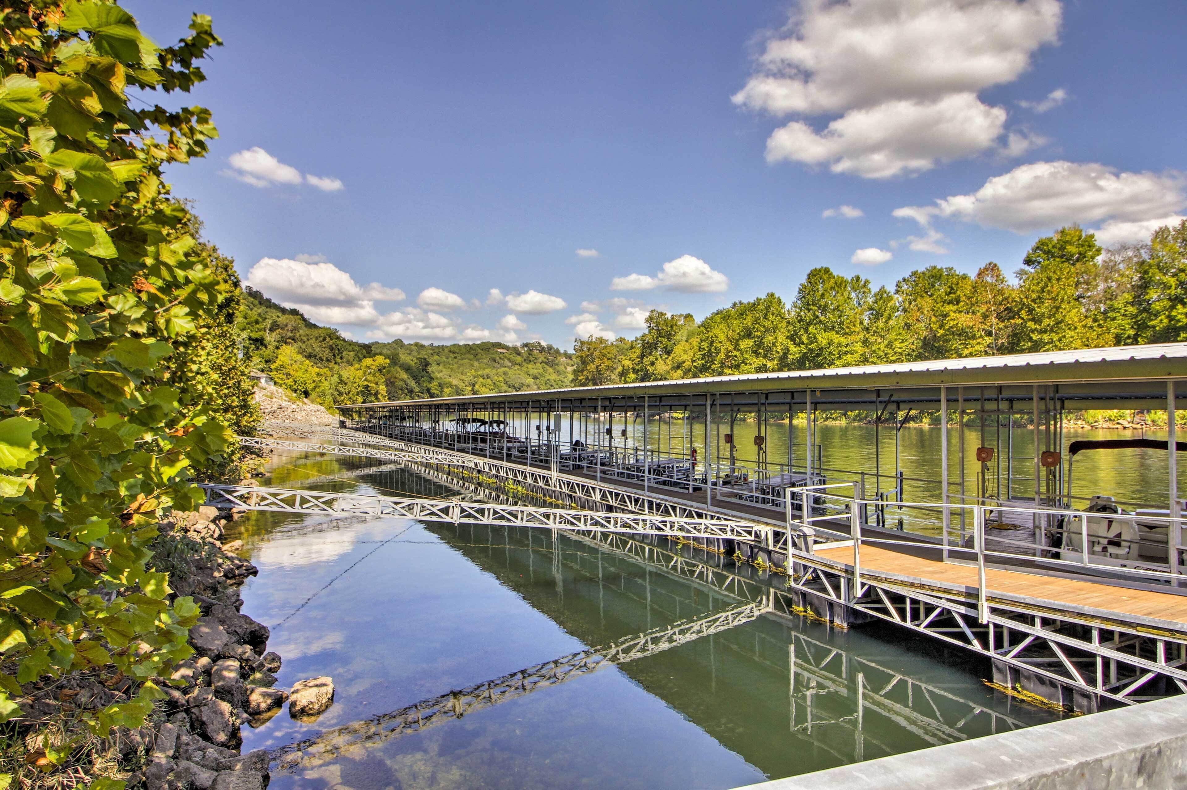 A bridge over a calm river with a wooden walkway and metal railings.