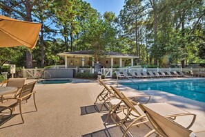 A pool area with lounge chairs and a covered seating area. - Pool Deck Access & Walk to Beach: Hilton Head Unit (Hilton Head Island)