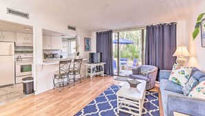 A compact living space with a kitchenette, a dining area, and a seating area with a sofa and armchairs. - Patio & Walk to Beach: Hilton Head Island Townhome (Hilton Head Island)