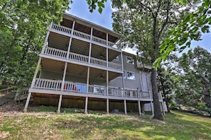 A two-story house with a balcony on the ground floor and a second-floor balcony.
