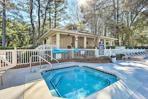 A pool area with a small pool, a covered seating area, and a building with a porch. - Walk to Beach: Hilton Head Condo w/ Pool Access (Hilton Head Island)