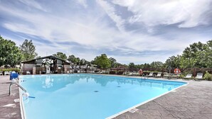 A swimming pool with a covered area, lounge chairs, and a fenced deck. - Holiday Hills Resort Condo: 3 Mi to Branson Strip! (Branson)