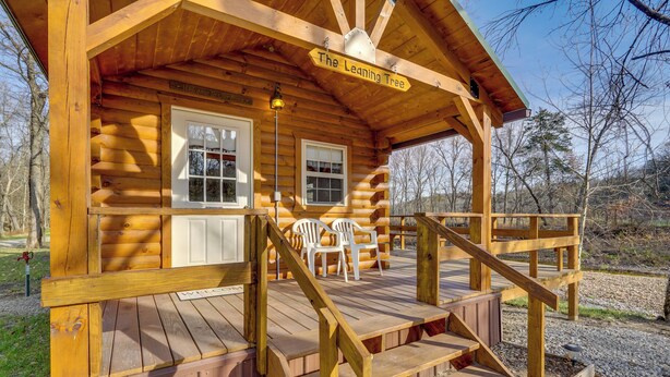 A wooden cabin with a porch, two windows, and a sign reading "The Leaning Tree". - Creek Views & Grill: Idyllic Florence Cabin (Florence)