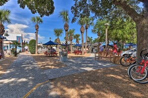 A park with palm trees, picnic tables, and bicycles. - Pool Access: Idyllic Sea Pines Gem, Walk to Beach (Hilton Head Island)