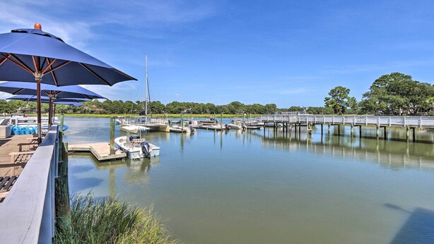 A marina with docked boats, a wooden deck, and a bridge. - Pool Access: Idyllic Sea Pines Gem, Walk to Beach (Hilton Head Island)