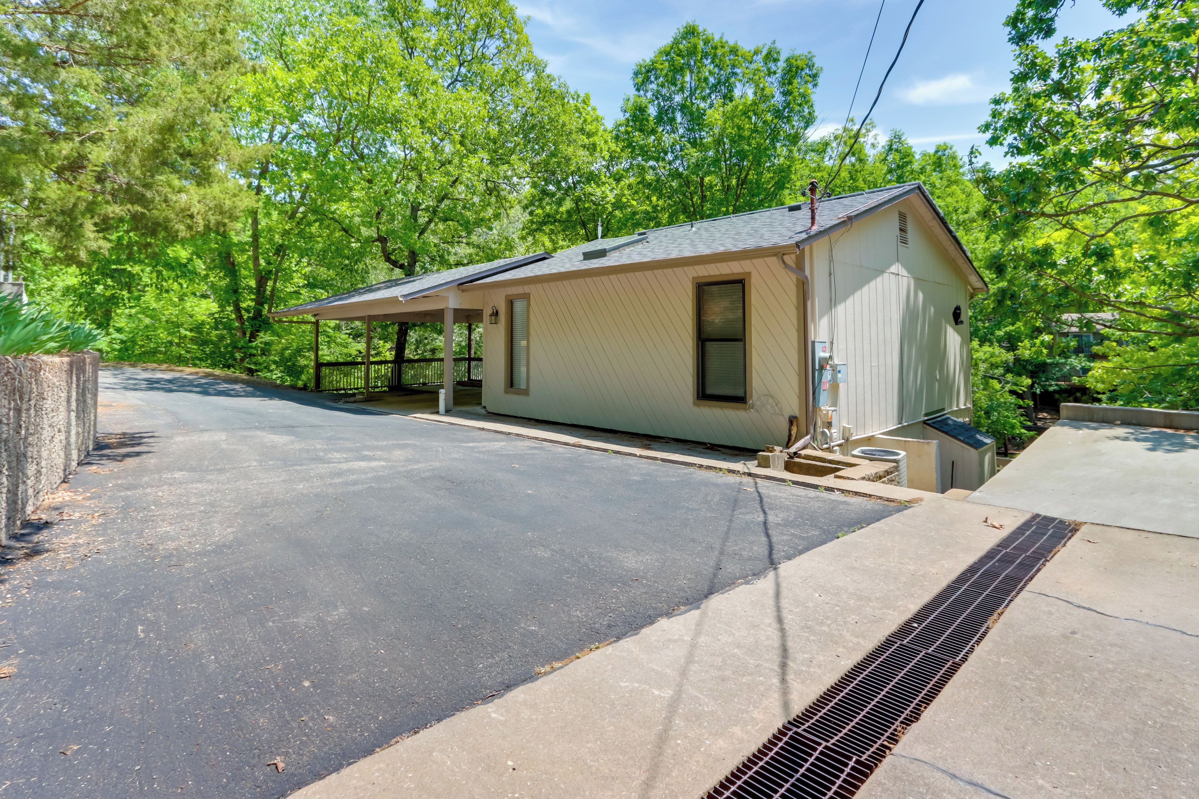 A small, single-story building with a covered porch and a garage.