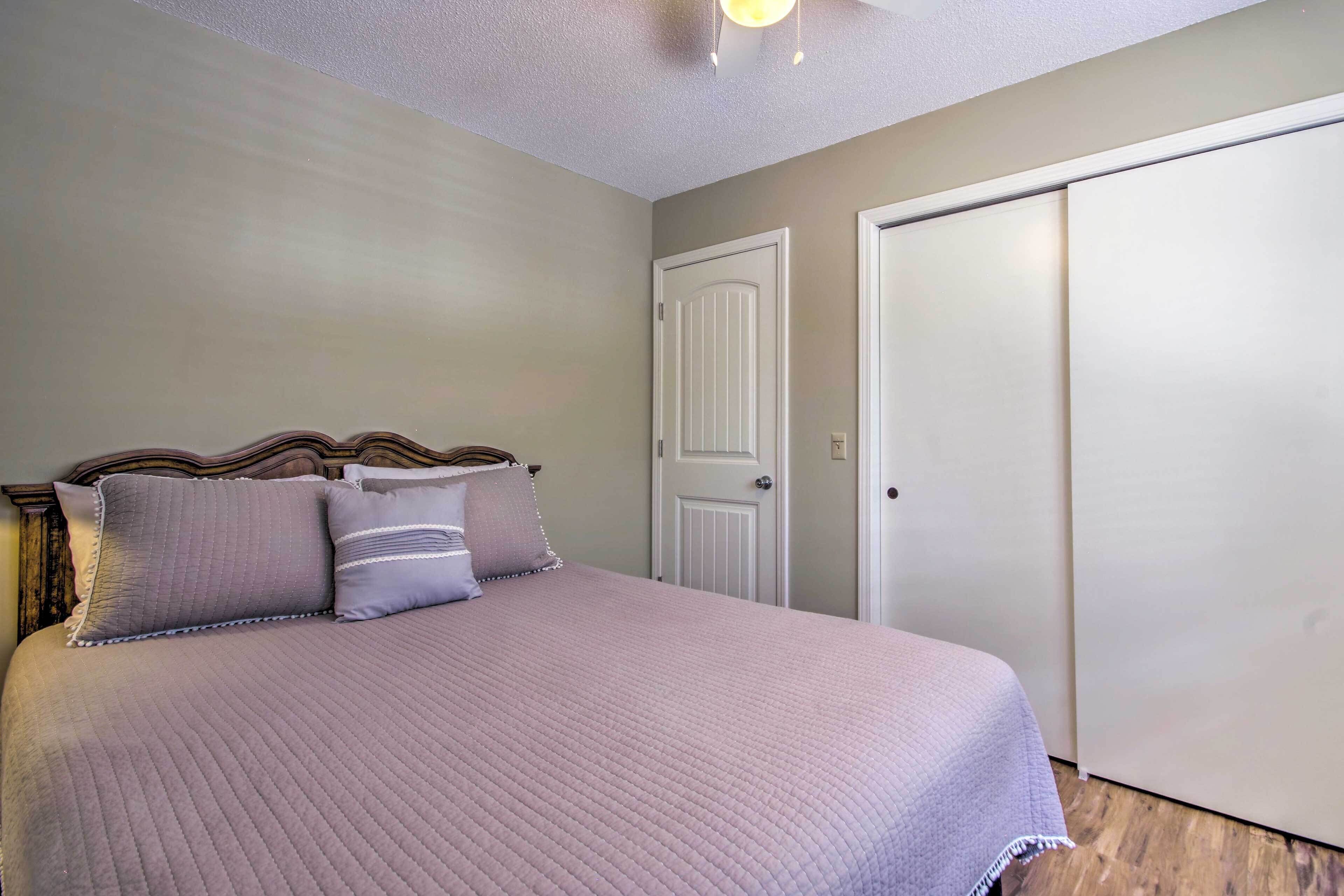 A bedroom with a bed, a wardrobe, and a door.
