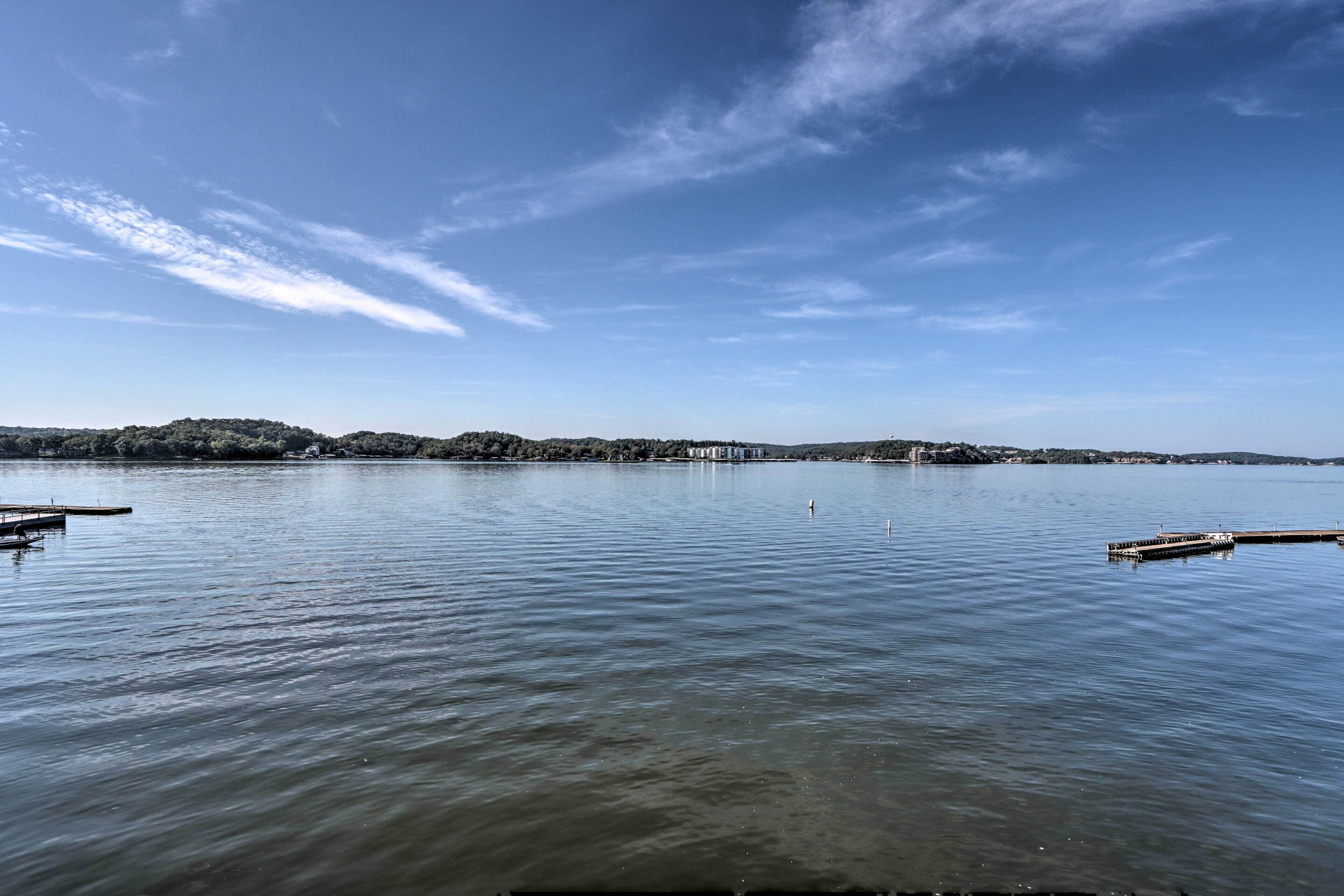 A calm lake with docks and a distant shoreline.