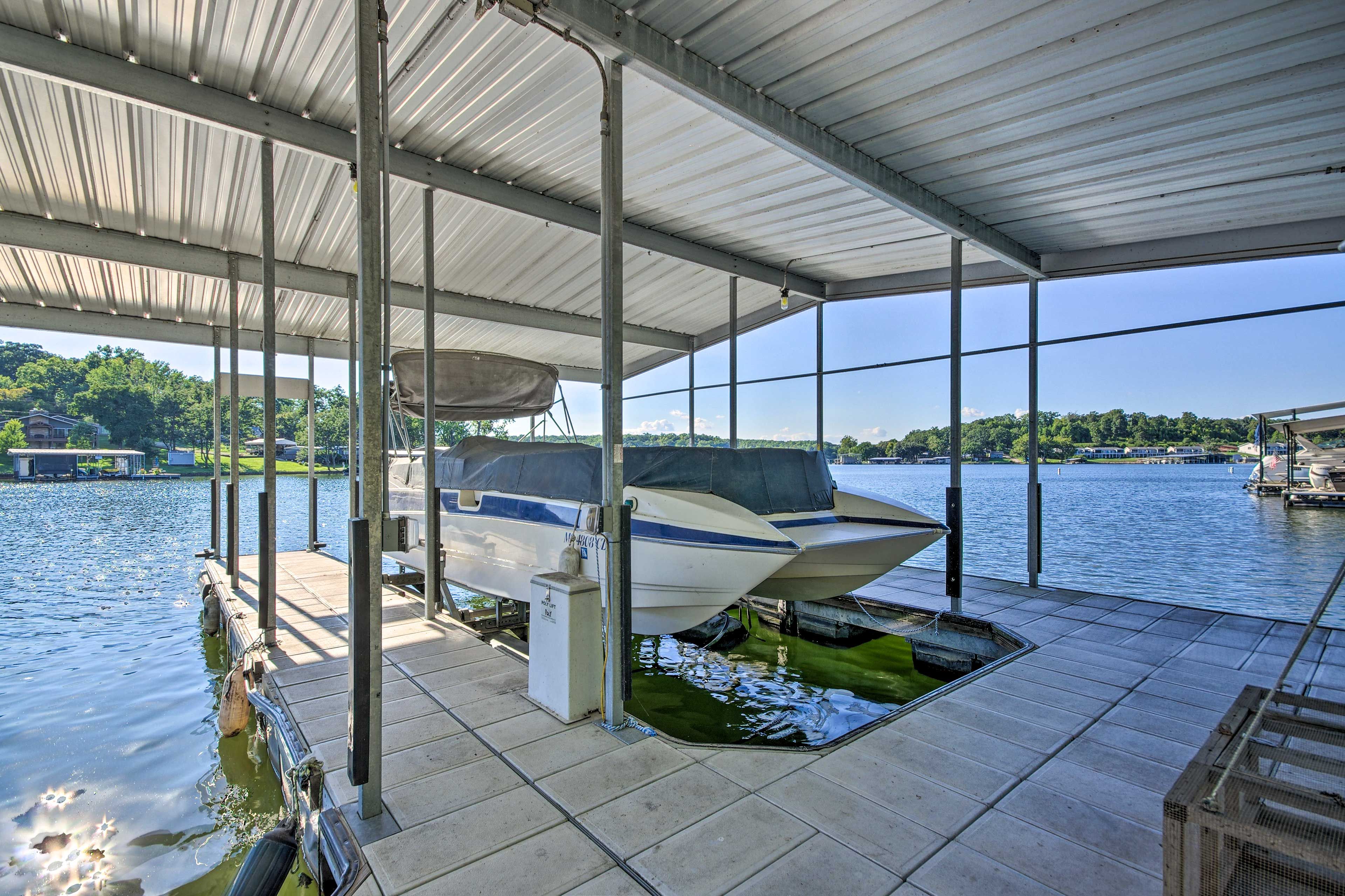 A covered boat dock with a boat moored underneath.