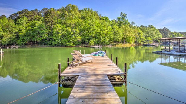 A wooden dock extending into a calm lake, surrounded by lush green trees. - Lakefront Townville Gem w/ Boat Dock & Kayaks (Townville)