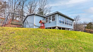 A two-story house with a large front porch, a small attached garage, and a sloped roof. - 8 Mi to Beach: Lake-view Haven in Linn Creek! (Linn Creek)
