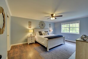 A bedroom with a bed, bedside tables, a ceiling fan, and a window. - Modern Home w/ Yard + Deck, 1 Mi to Clemson U! (Clemson)