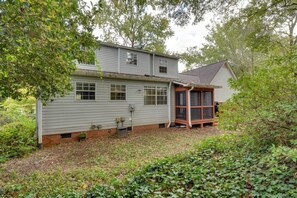 A two-story house with a porch, a garage, and a small garden area. - Modern Home w/ Yard + Deck, 1 Mi to Clemson U! (Clemson)
