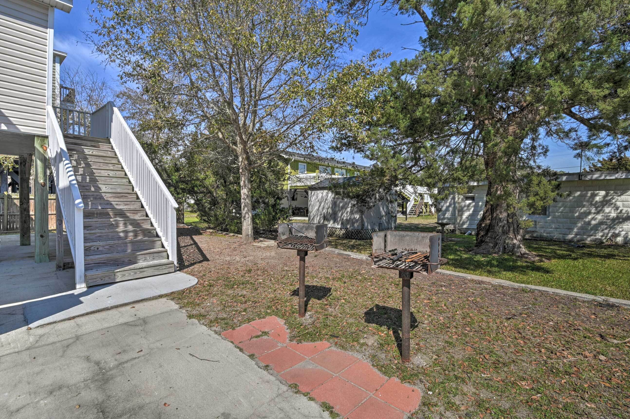 A residential area with a wooden staircase leading to a porch, a mailbox, and a stone wall.