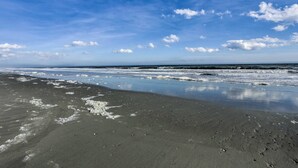 A beach with a clear sky and calm waves. - Magnolia Pointe Condo With Community Pool & More! (Myrtle Beach)