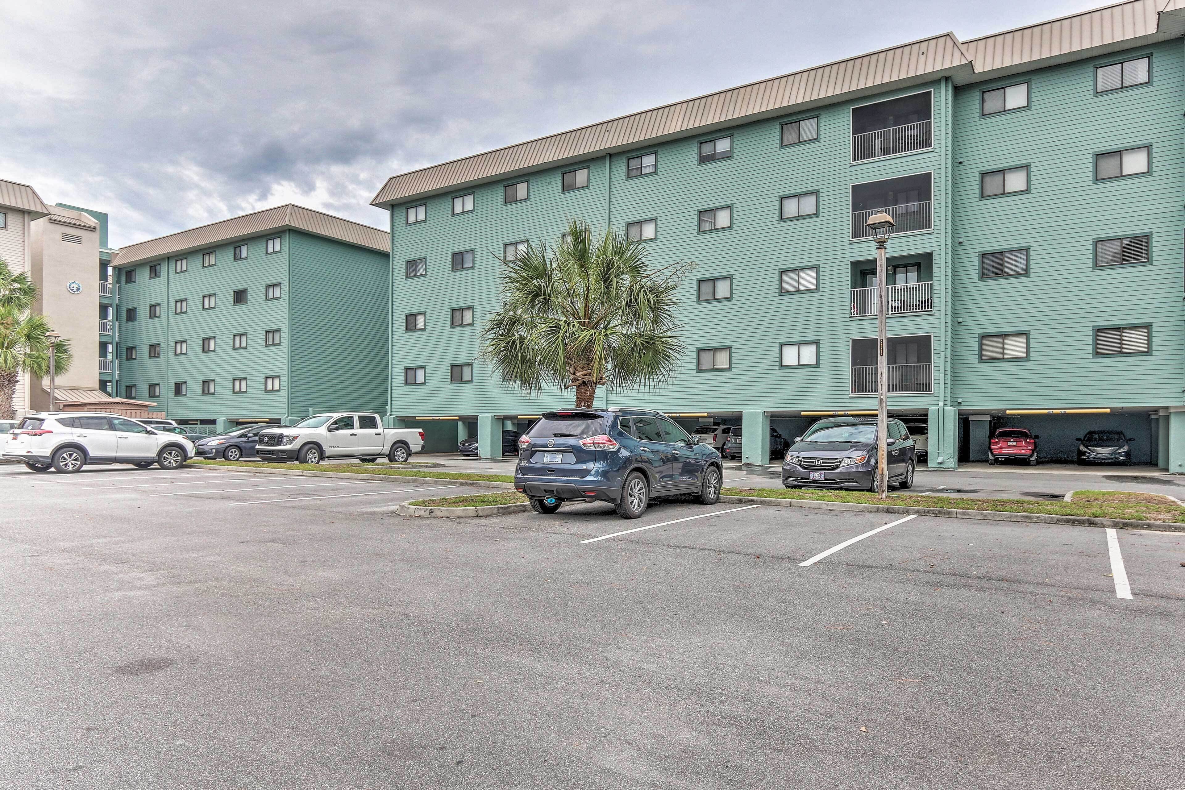 A multi-story hotel with a parking lot.