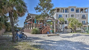 A beachfront property with a wooden deck, a bicycle, and a sign reading "Oceanview." - Walk to Beach: Nautical Hilton Head Resort Condo! (Hilton Head Island)