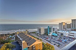 A coastal hotel with a parking lot, multiple buildings, and a view of the ocean. - Walk to Ocean: Myrtle Beach Condo w/ Views! (Myrtle Beach)
