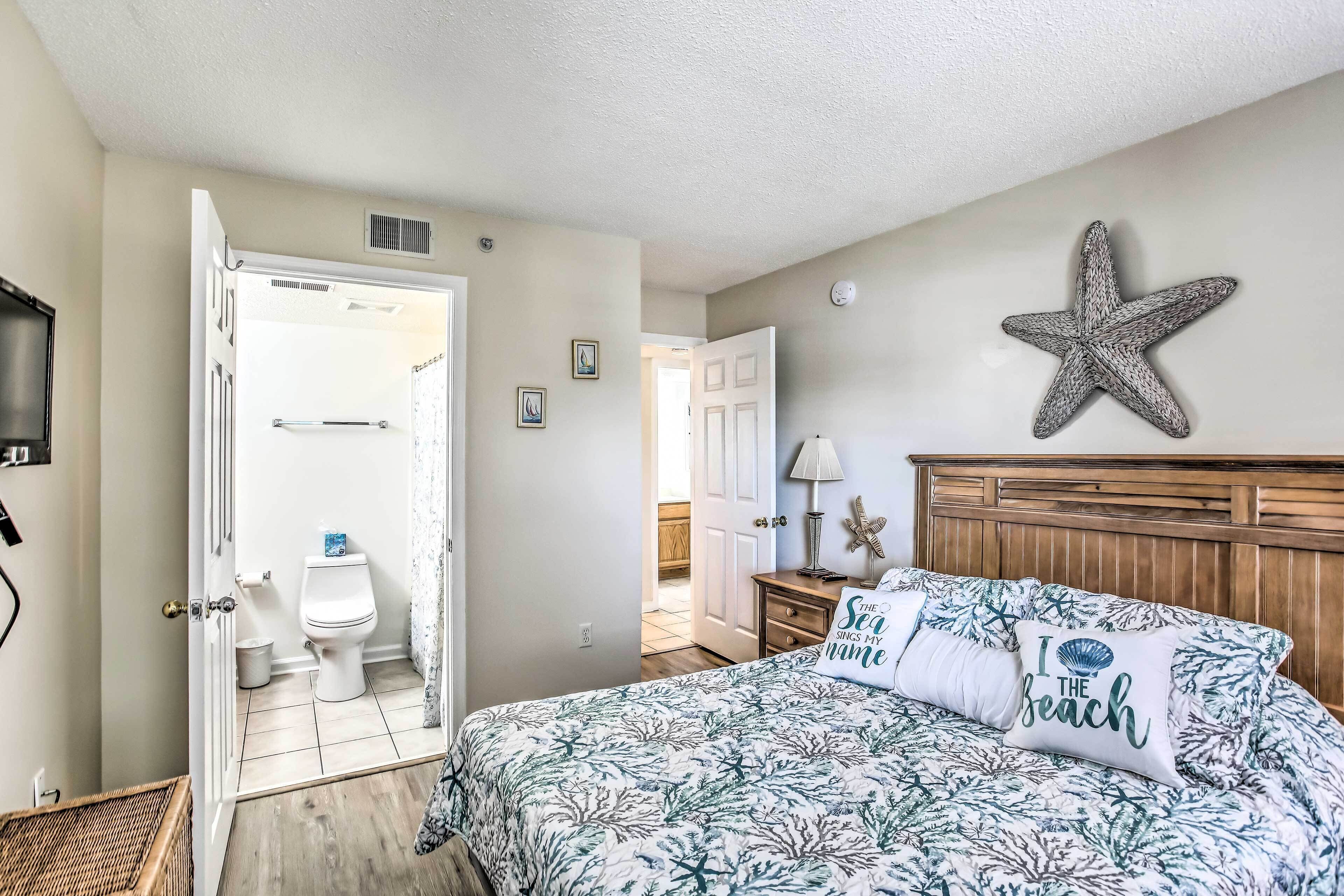 A bedroom with a bed, a starfish decoration, and a pillow with a beach theme.