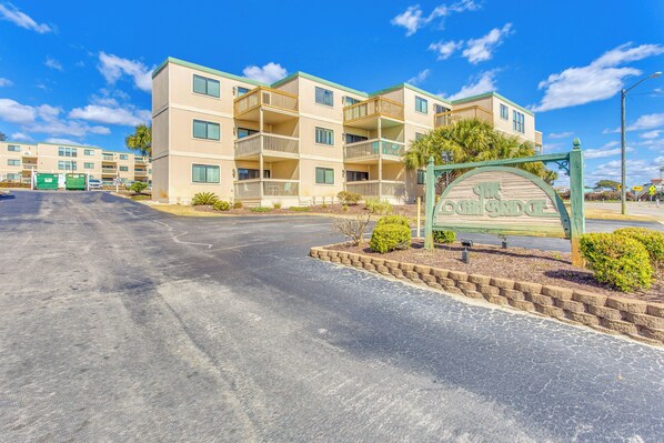 A multi-story hotel with balconies, a parking lot, and a sign reading "The Oceanview."