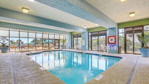 An indoor swimming pool with clear glass walls, a lifeguard sign, and a no lifeguard warning sign. - Walk to Shore: Condo w/ 2 Pools in Myrtle Beach (Myrtle Beach)
