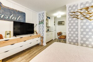 A modern kitchen with white cabinets, a built-in oven, and a microwave. - Walkable Studio in North Myrtle Beach! (North Myrtle Beach)