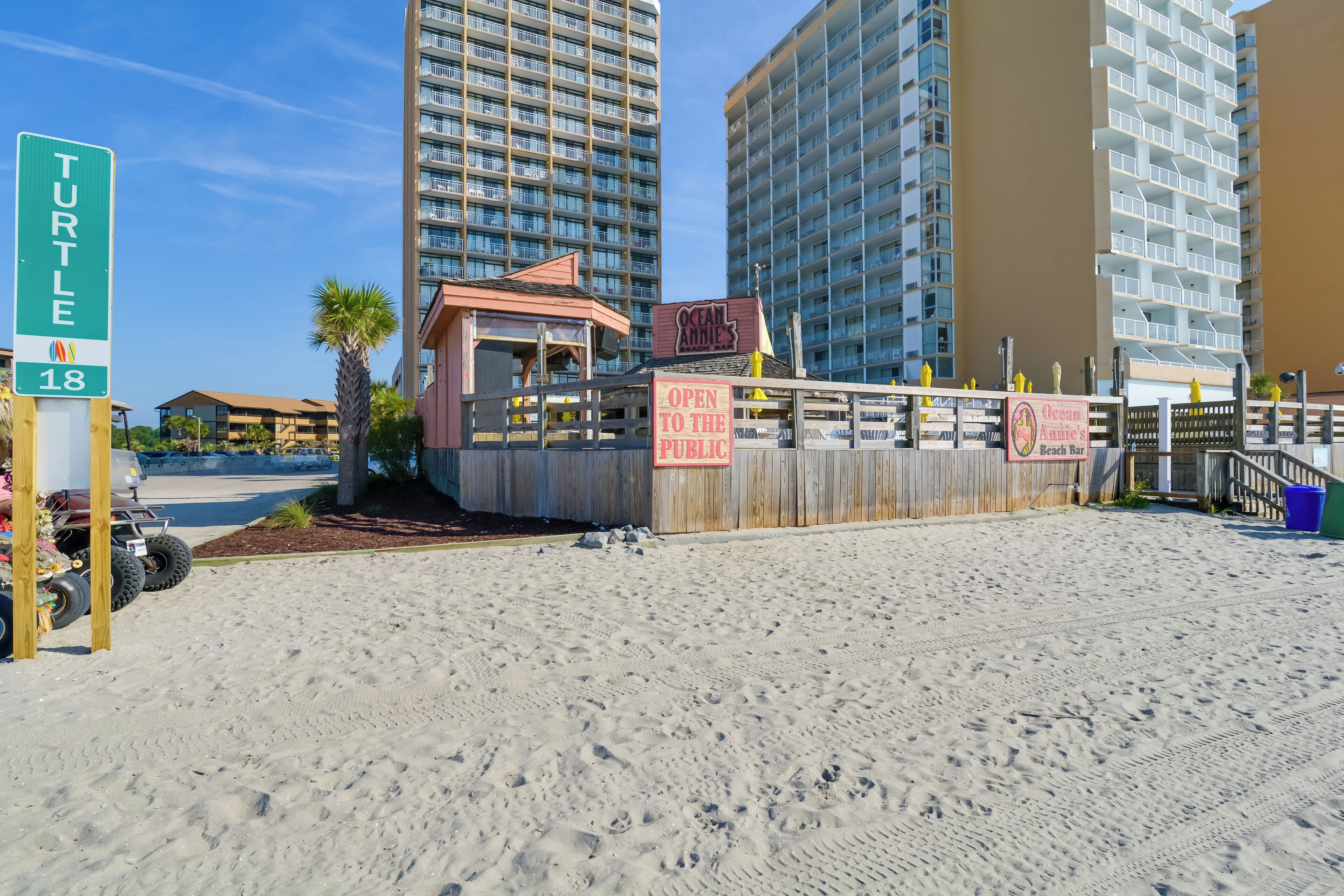 A beachside property with a sign indicating 'TURTLE 18' and 'OPEN TO THE PUBLIC'.