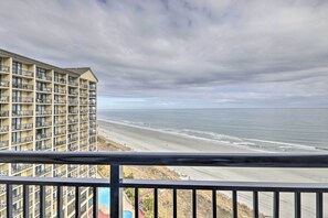 A high-rise hotel with multiple balconies overlooking a beach. - Oceanfront Condo w/ Views in North Myrtle Beach! (North Myrtle Beach)