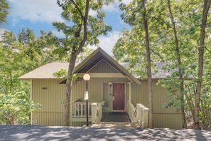 A small, single-story building with a front porch, a door, and a small staircase leading to the entrance.