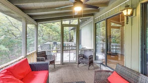 A covered porch with wicker furniture, a ceiling fan, and a view of the outdoors. - 2 Decks & Pool Access: Osage Beach Retreat (Osage Beach)