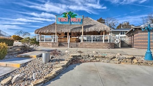 A tiki hut with a sign reading "TIKI HUT POOL BAR" and a thatched roof. - Furnished Deck! Golfer's Oasis in Margaritaville (Osage Beach)